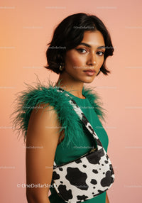 Elegant Woman with Green Dress and Cow Print Handbag
