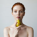 Portrait of a Young Woman with Red Hair Holding a Pear