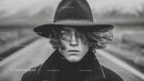 Stylish Young Man with Wet Hair Outdoors in Moody Black and White Portrait