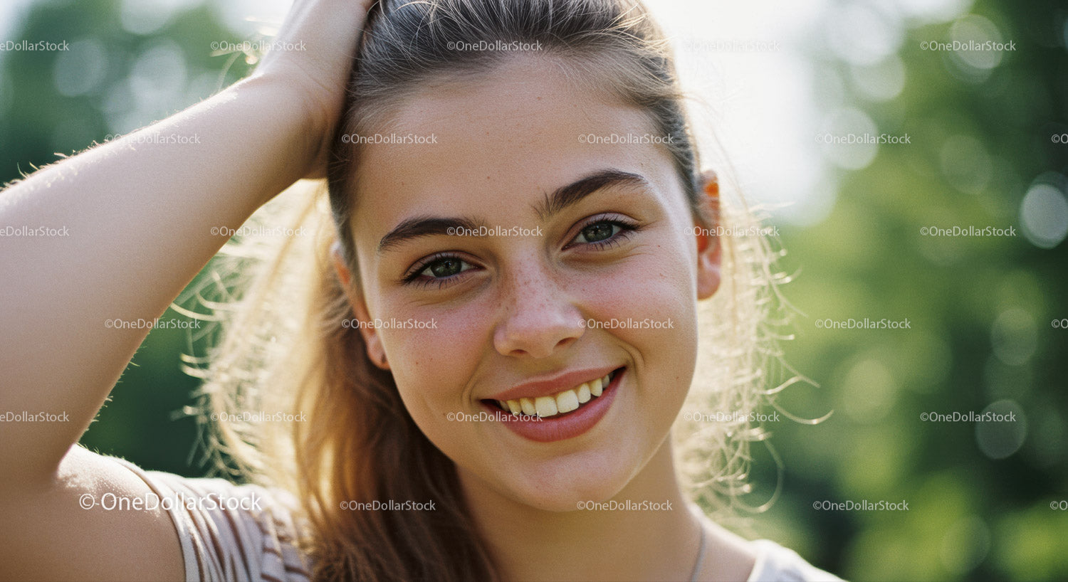 Close-up of a Happy Young Woman Smiling Outdoors in Bright Sunlight