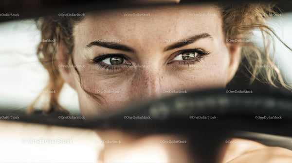 Close-up of Woman Driving a Car with Striking Green Eyes