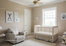 Bright Baby Nursery with Crib Armchair and Wall Art in Cozy Home