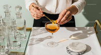 Elegant Orange Peel Gin Cocktail in Vintage Glass with Bar Accessories