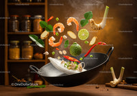 Fresh Thai ingredients flying out of wok with steam