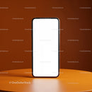 Modern smartphone with blank screen on orange surface