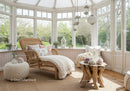 Cozy sunlit wicker lounge in a bright garden room