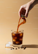 Pouring cold brewed coffee into ice-filled glass