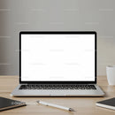 Modern laptop with blank screen on wooden desk setup