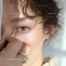 Close-up of Woman Applying Eye Shadow with Cosmetic Brush