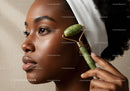 Elegant African Woman Using Jade Roller for Skin Rejuvenation