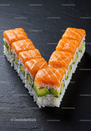 Fresh salmon avocado sushi arranged in V shape on slate