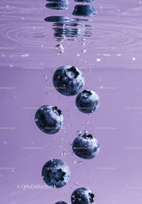 Fresh blueberries submerged in clear water bubbles