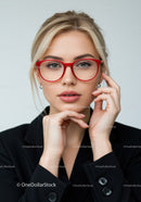 Elegant Woman with Blonde Hair and Red Glasses in Studio Portrait