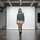 Fashion model walking in studio with casual winter outfit