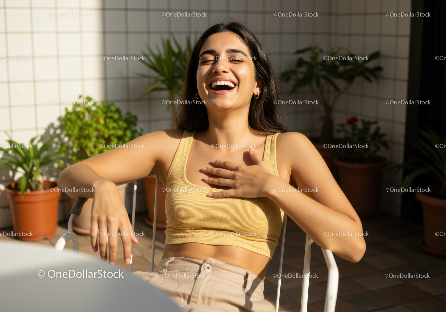Joyful Woman Laughing Outdoors with Sunlight and Greenery