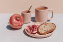 Fresh Fruit and Tea Breakfast Scene with Pomegranate and Bread