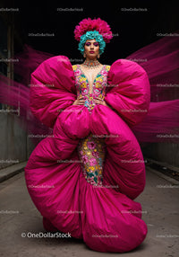 Fashion Model in Vibrant Pink and Yellow Flowing Gown