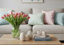 Cozy living room with pastel pillows and tulip bouquet