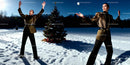 Woman posing with snowball near decorated Christmas tree