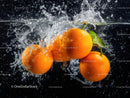 Vibrant Oranges Splashing into Water in Dynamic Close-Up