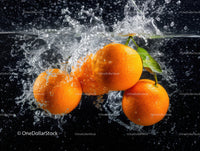 Vibrant Oranges Splashing into Water in Dynamic Close-Up
