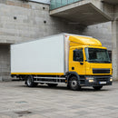 Yellow Delivery Truck Parked Near Urban Concrete Walls