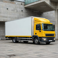 Yellow Delivery Truck Parked Near Urban Concrete Walls