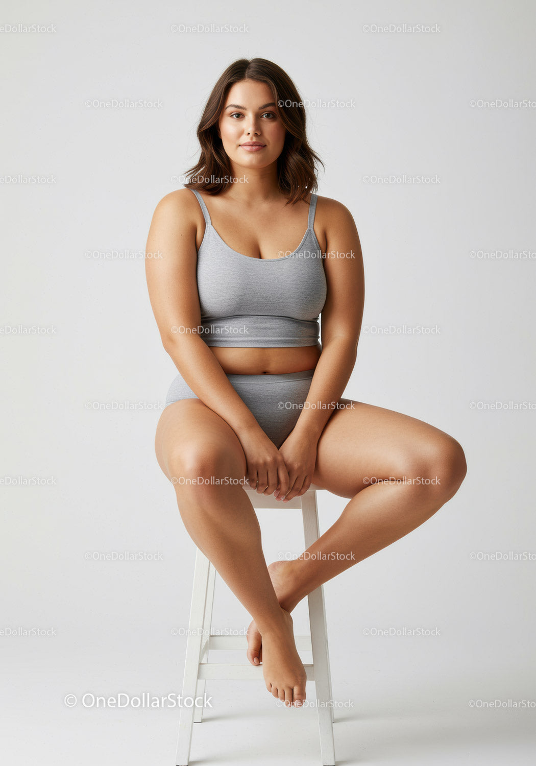 Young Woman Sitting Cross-Legged on Stool in Casual Sportswear
