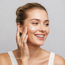Young Woman Applying Moisturizer for Smooth Youthful Skin