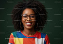 Joyful woman with curly hair and glasses wearing colorful striped shirt