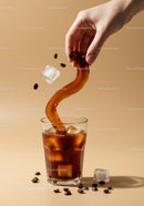 Pouring Iced Coffee with Floating Beans and Ice Cubes