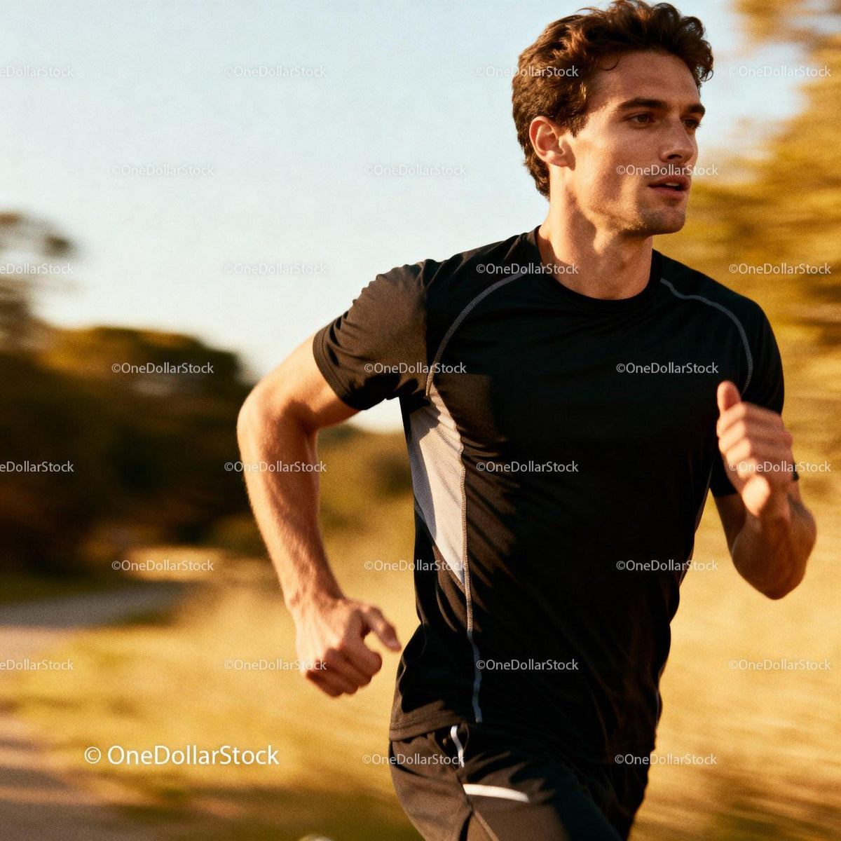 Focused young man running outdoors in sunset light
