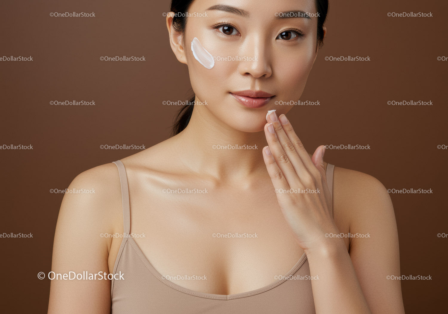 Young Woman Applying Facial Moisturizer for Radiant Skin