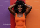 Colorful Portrait of a Smiling Woman in Orange Dress Against Multi-Colored Wall