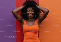Colorful Portrait of a Smiling Woman in Orange Dress Against Multi-Colored Wall