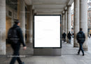 Blank urban billboard on busy pedestrian street