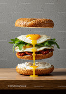 Sesame bun sandwich with fried eggs and arugula drizzle