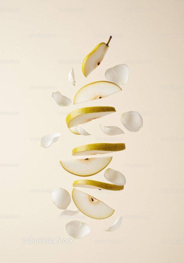 Floating Sliced Pear Surrounded by White Petals