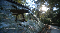 Abandoned Vintage Car with Broken Glass at Sunset