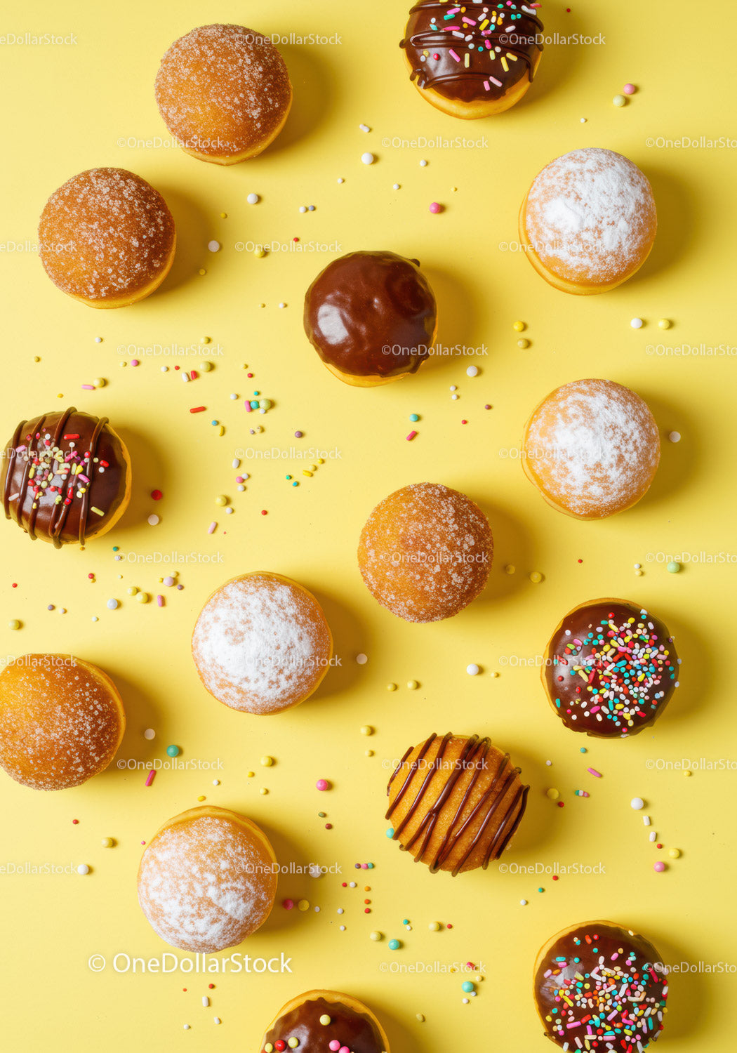 Assorted sweet donuts with colorful sprinkles on yellow