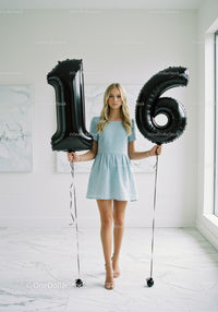 Teenage Girl Celebrating Sixteenth Birthday with Balloons