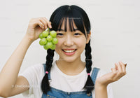 Young Girl Holding Fresh Green Grape Bunch With Smiling Face