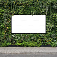 Blank billboard surrounded by lush green plants wall