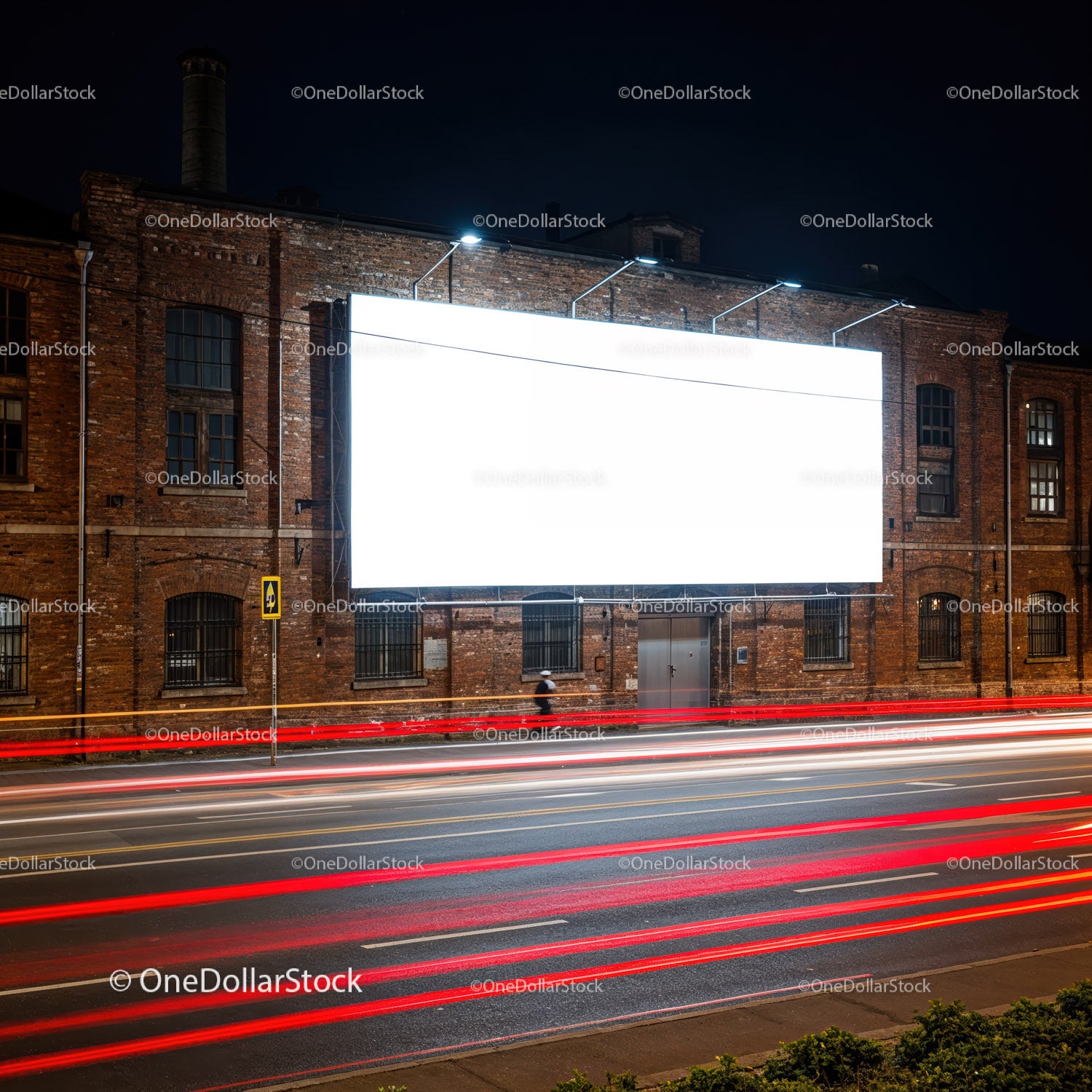 Podświetlony billboard na ceglanej ścianie nocą na ulicy miasta