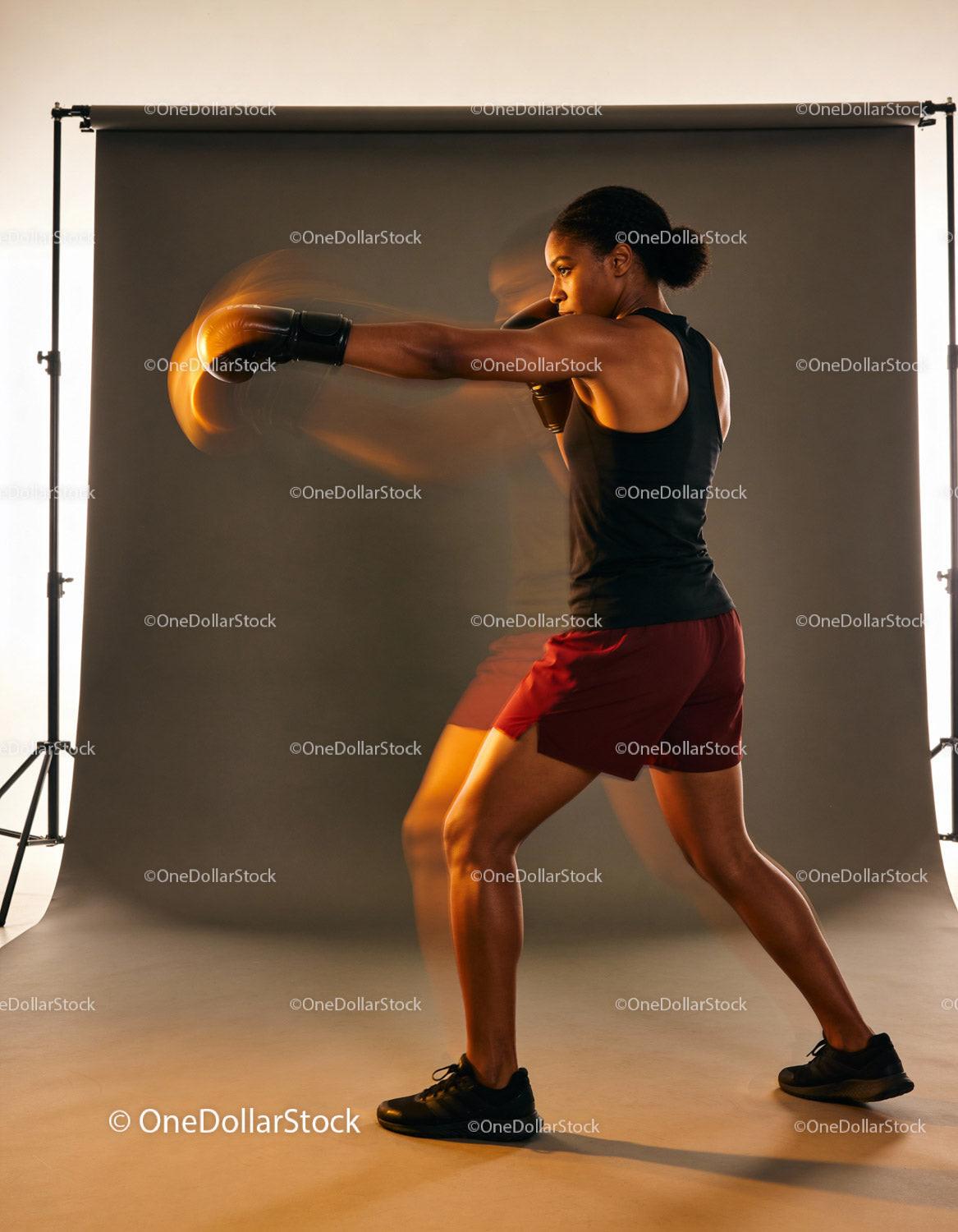 Athletic woman delivering a powerful boxing punch