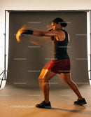 Athletic woman delivering a powerful boxing punch