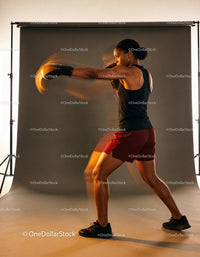 Athletic woman delivering a powerful boxing punch