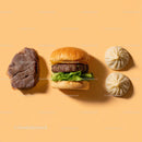 Gourmet Burger with Lettuce and Tomato Next to Grilled Steak and Dumpling