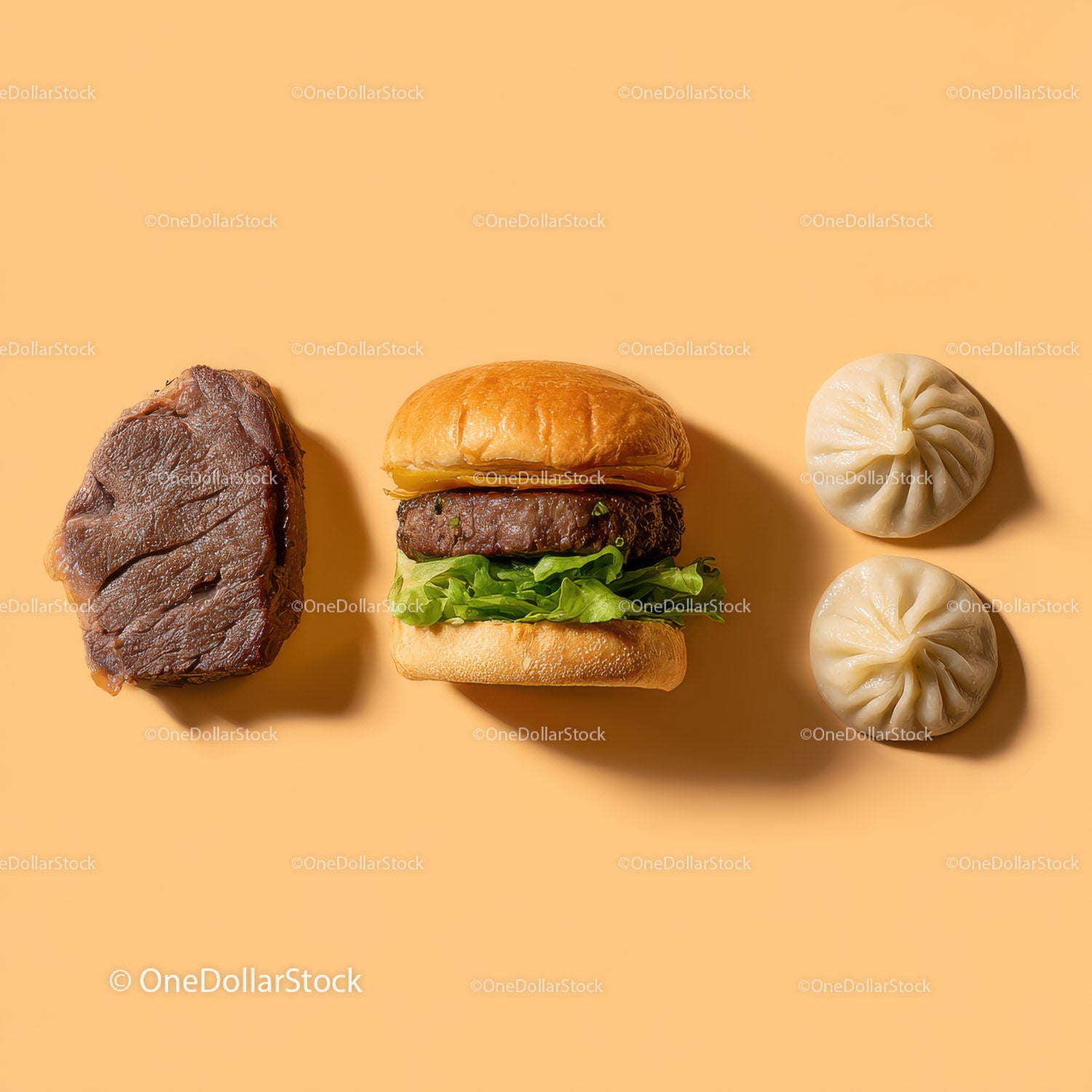 Gourmet Burger with Lettuce and Tomato Next to Grilled Steak and Dumpling