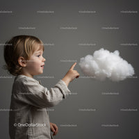 Curious child reaching out to fluffy white cloud